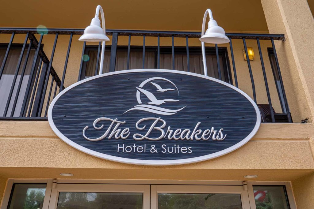 Blue sign with logo of The Breakers Hotel and Suites